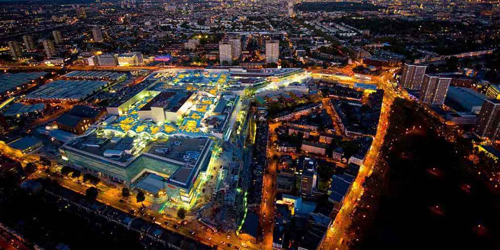 Aerial night view of a shopping centre complex with illuminated engineering and infrastructure systems